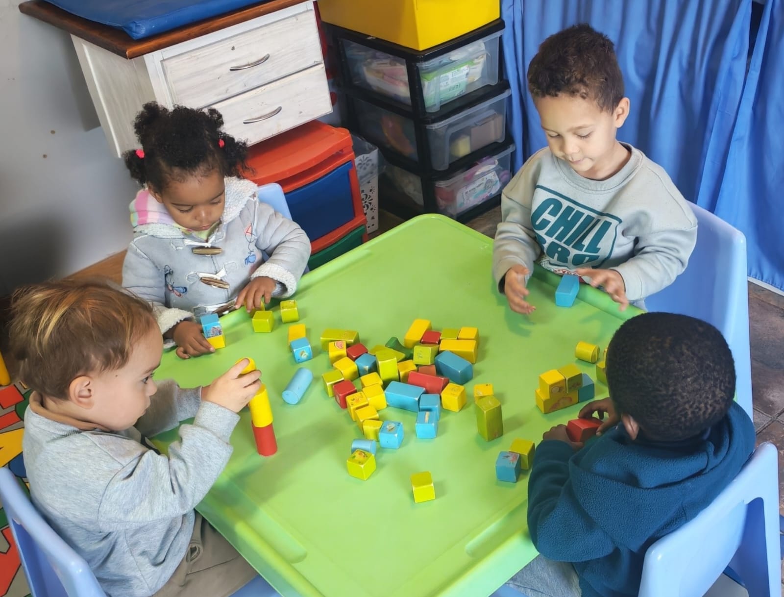 Children building with colourful blocks