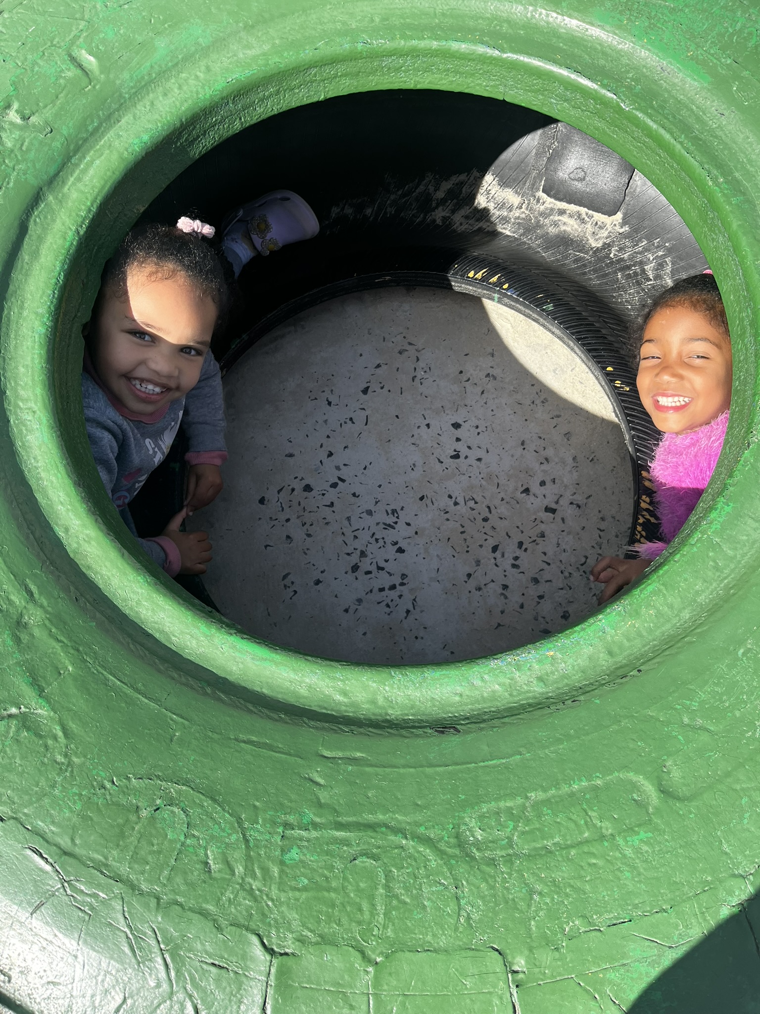 Children playing in the Ashron playground tunnel
