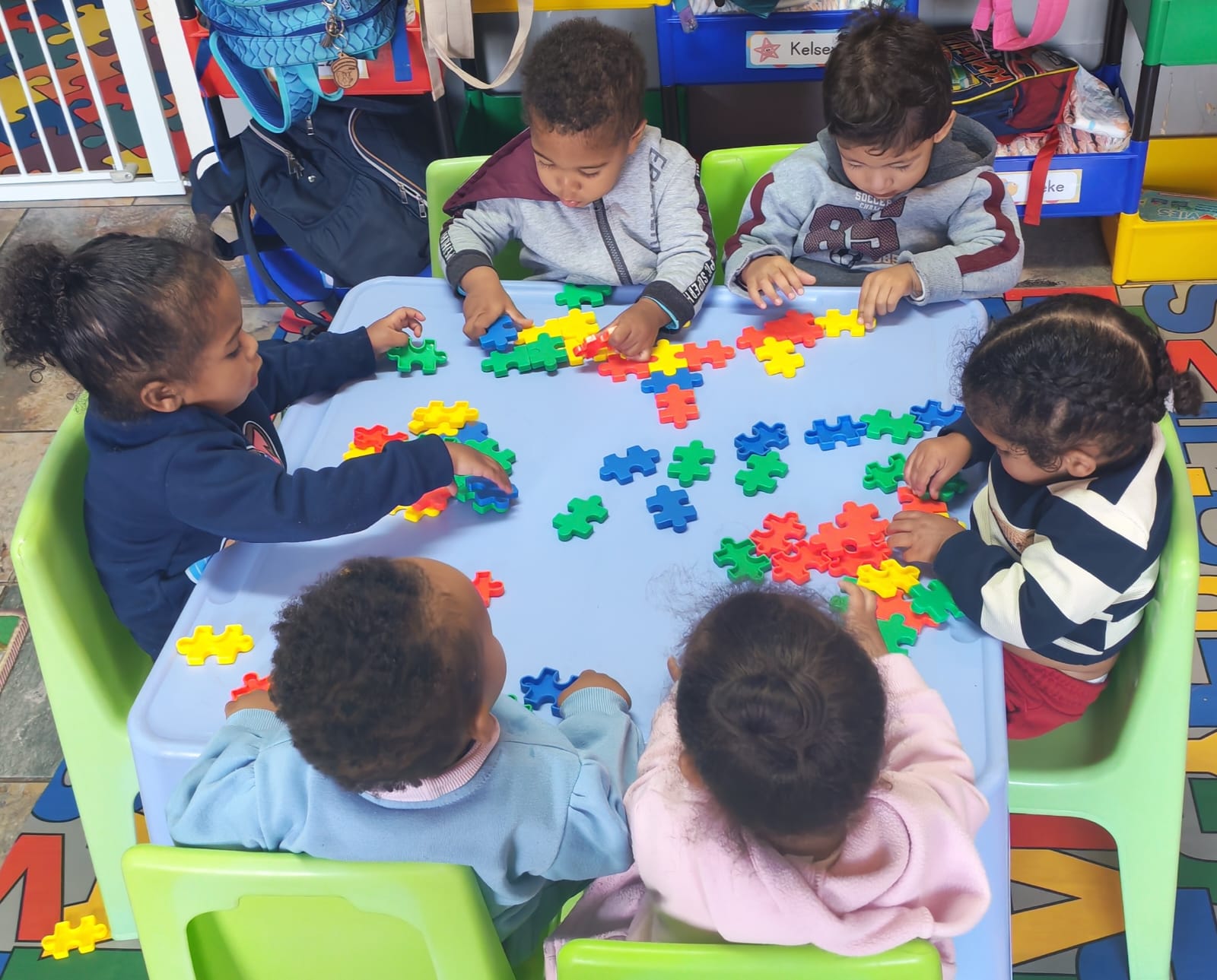 Children enjoying a classroom puzzle activity
